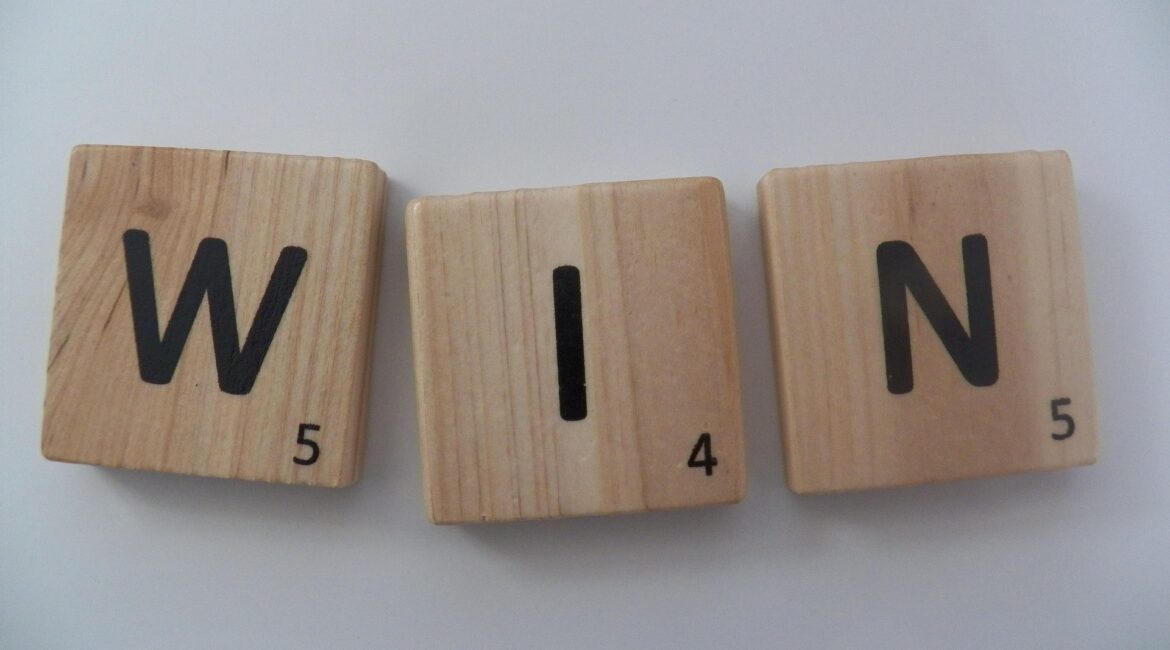 win 372770 1920 1 Three wooden Scrabble tiles displaying the letters W, I, and N, with numbers 5, 4, and 5 below each letter.